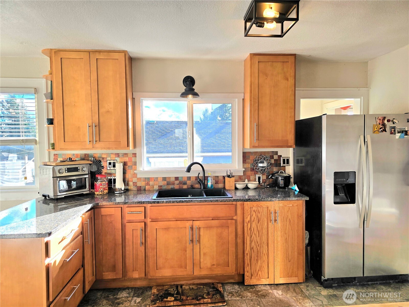 906 North Rice Street Aberdeen, WA 98520 - Photo 11 of 34 a kitchen with stainless steel appliances a refrigerator sink and cabinets