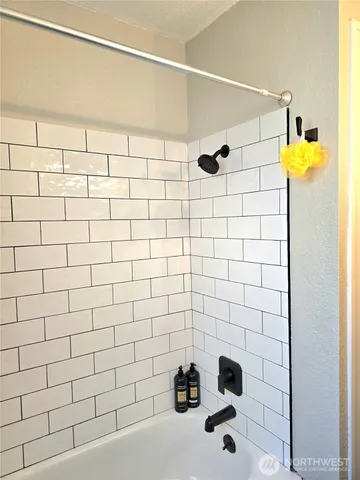 a bedroom with a large bed and a ceiling fan