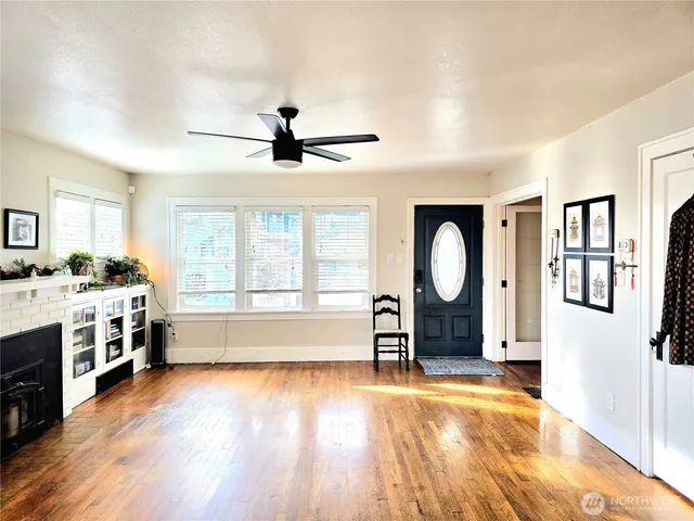 a living room with a stove and a kitchen view