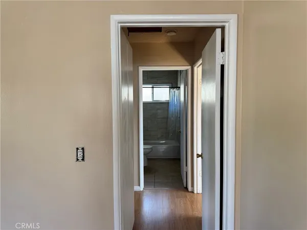 a view of a hallway with wooden floor
