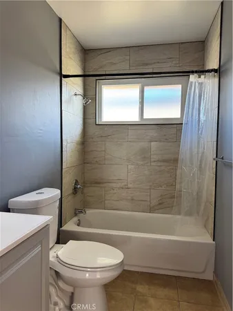 a bathroom with a toilet and a bathtub