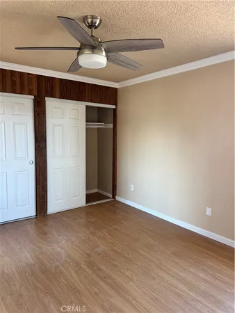 a view of an empty room with a ceiling fan