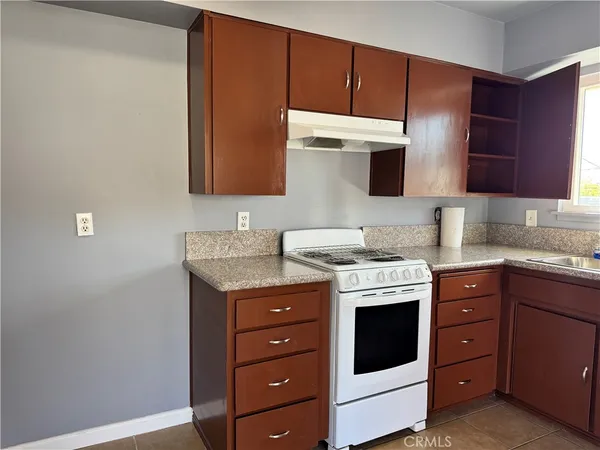 a kitchen with a stove microwave and cabinets