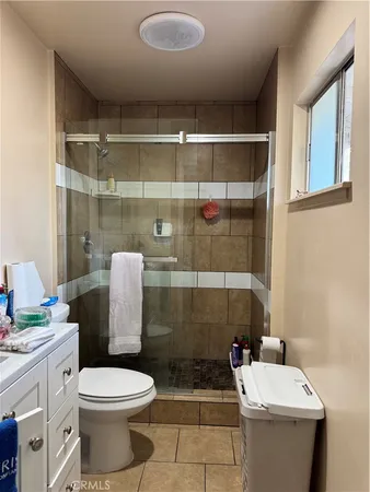 a bathroom with a toilet and a shower