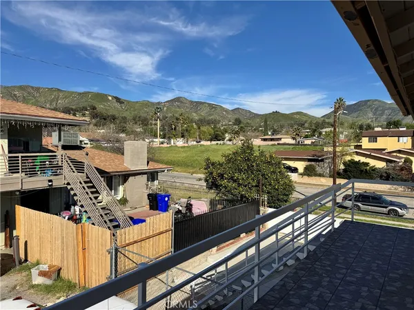 a view of a balcony with two chairs and a table