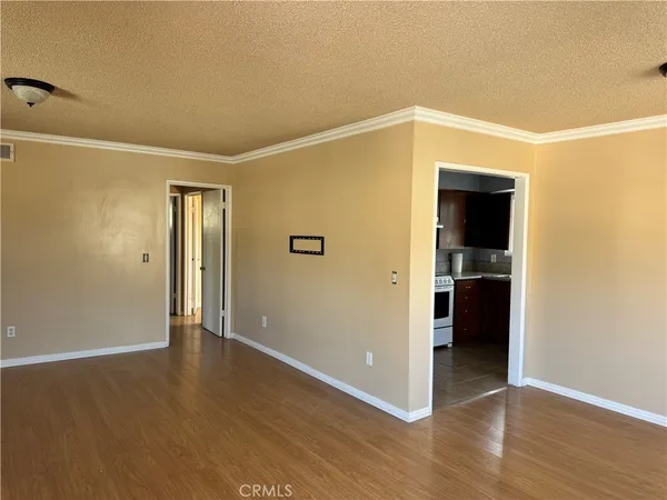 a view of a hallway with wooden floor and closet