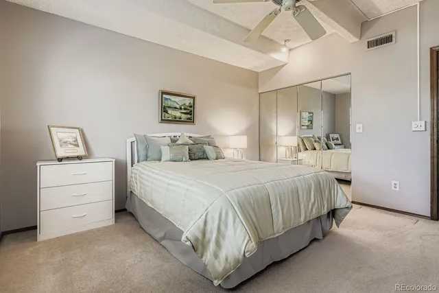 a bedroom with a bed and lamp