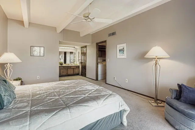 a bedroom with a bed and a lamp