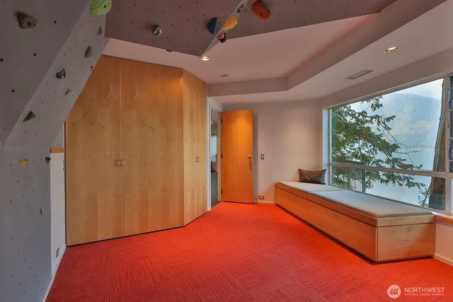 a spacious bedroom with a large window and a bed