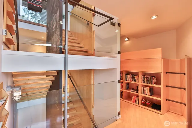 a bed sitting in a spacious bedroom next to a window