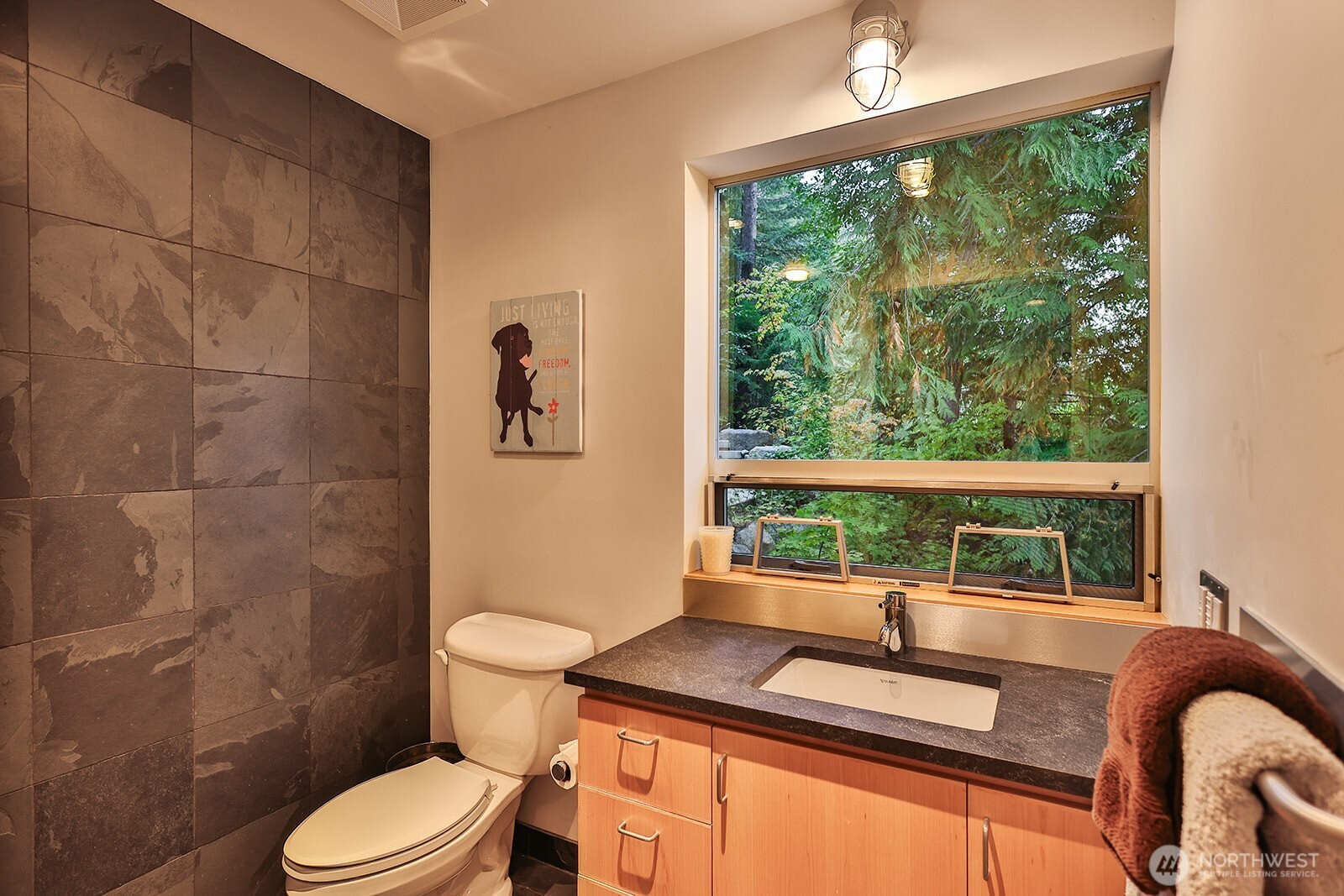 15810 Cedar Brae Road Leavenworth, WA 98826 - Photo 34 of 40 a bathroom with a granite countertop toilet a sink and a large mirror