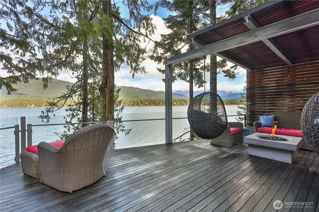 a living room with furniture a fireplace and large windows