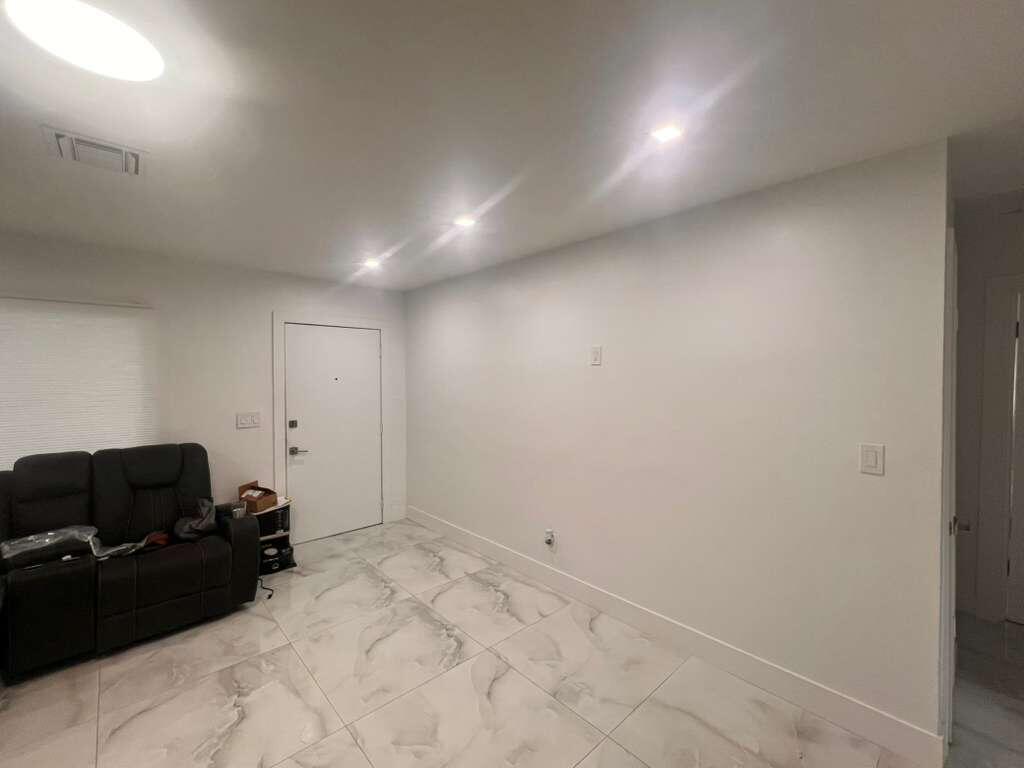 726 Southwest 7th Street, Unit 12 Hallandale Beach, FL 33009 - Photo 5 of 5 a view of a livingroom with furniture and clutter
