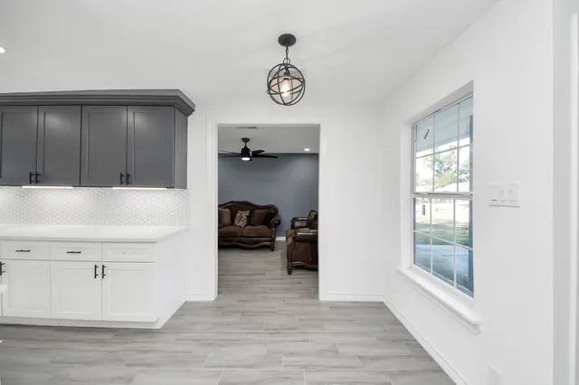 a view of utility room and bedroom with wooden floor