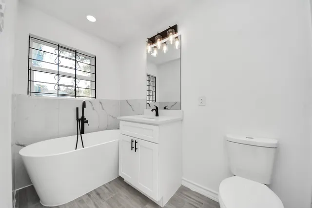 a bathroom with a sink a toilet and bathtub