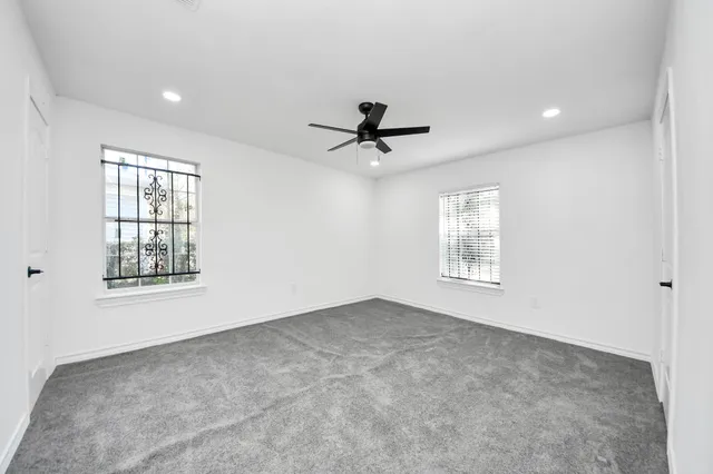a view of a livingroom with a ceiling fan and window