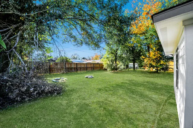 a view of yard with swimming pool and green space