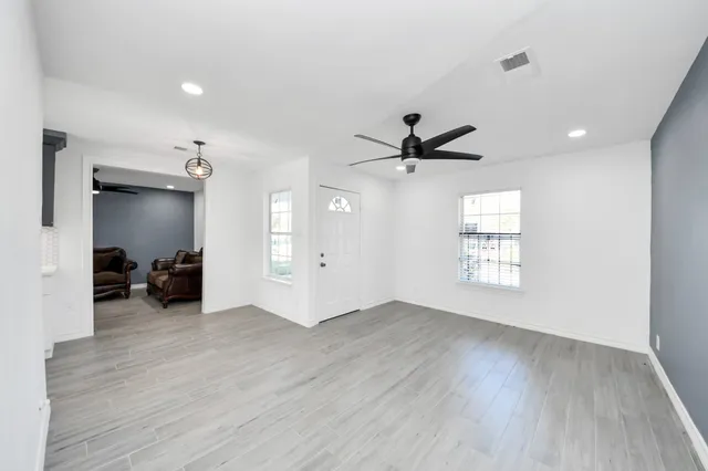 a view of a livingroom with a hardwood floor and a ceiling fan