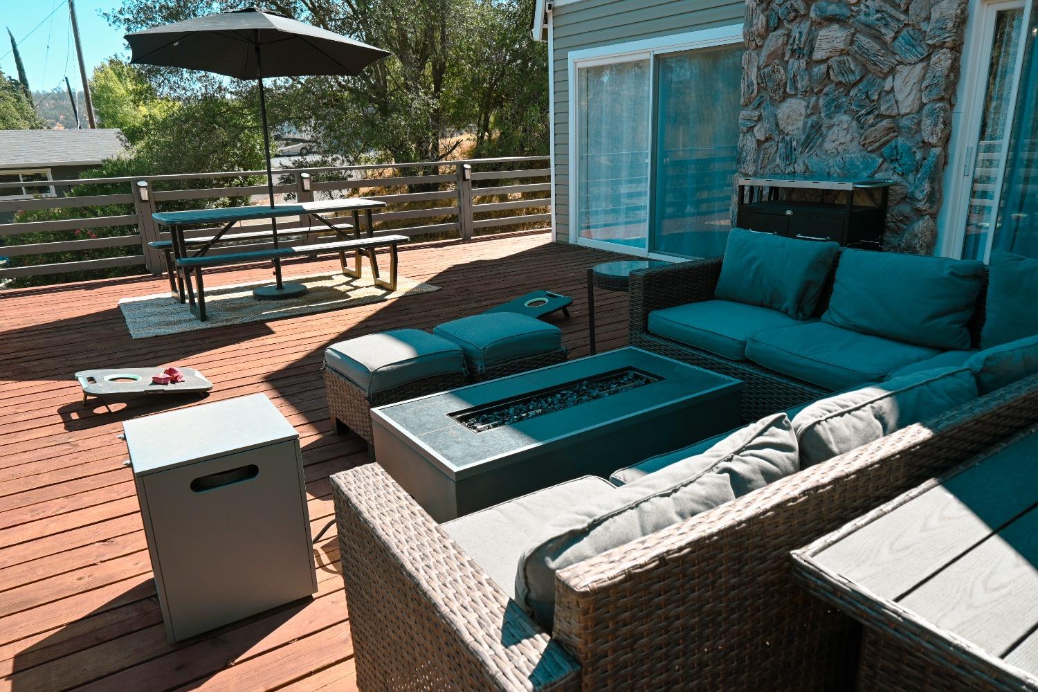 4220 Tomahawk Trail Copperopolis, CA 95228 - Photo 14 of 16 a roof deck with a table and chairs under an umbrella with wooden floor