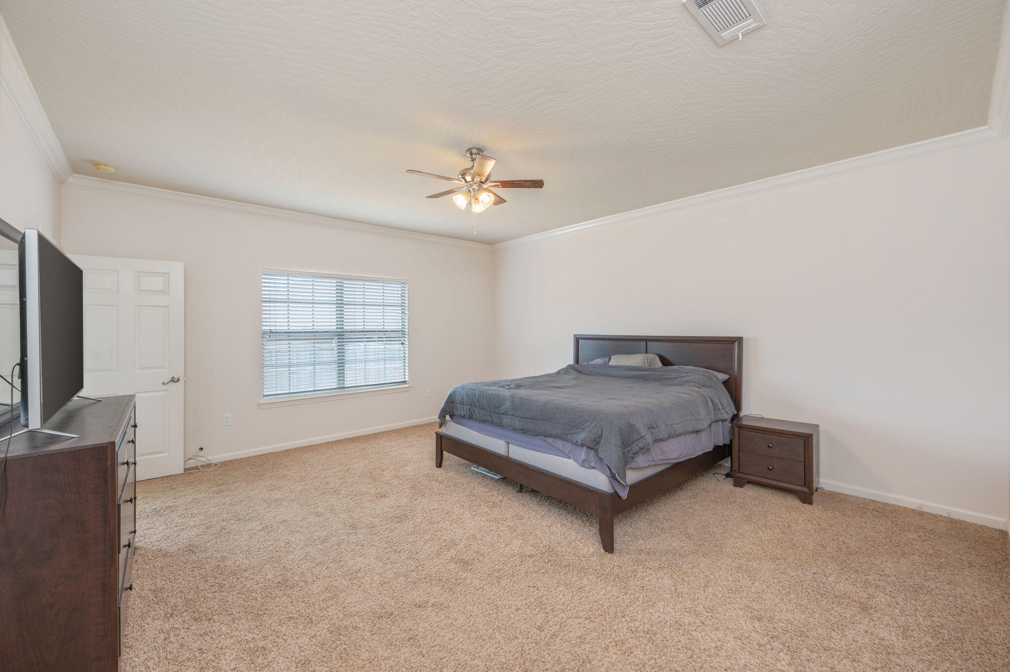 4627 Hermosa Road Crestview, FL 32539 - Photo 22 of 40 a spacious bedroom with a bed and a chandelier