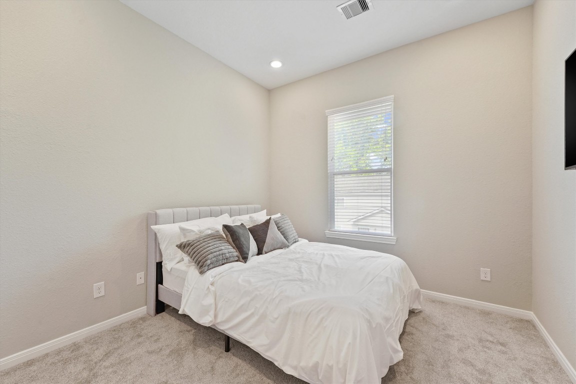 5620 Madison Street Houston, TX 77091 - Photo 14 of 17 a bedroom with a bed and a window