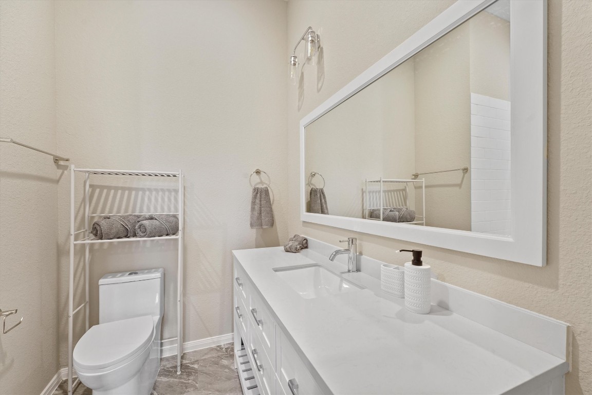 5620 Madison Street Houston, TX 77091 - Photo 15 of 17 a bathroom with a toilet a sink and a mirror