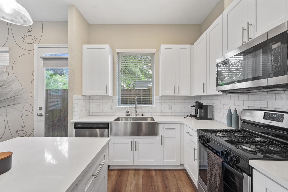 5620 Madison Street Houston, TX 77091 - Photo 6 of 17 a kitchen with stainless steel appliances granite countertop a stove a sink and a white cabinets