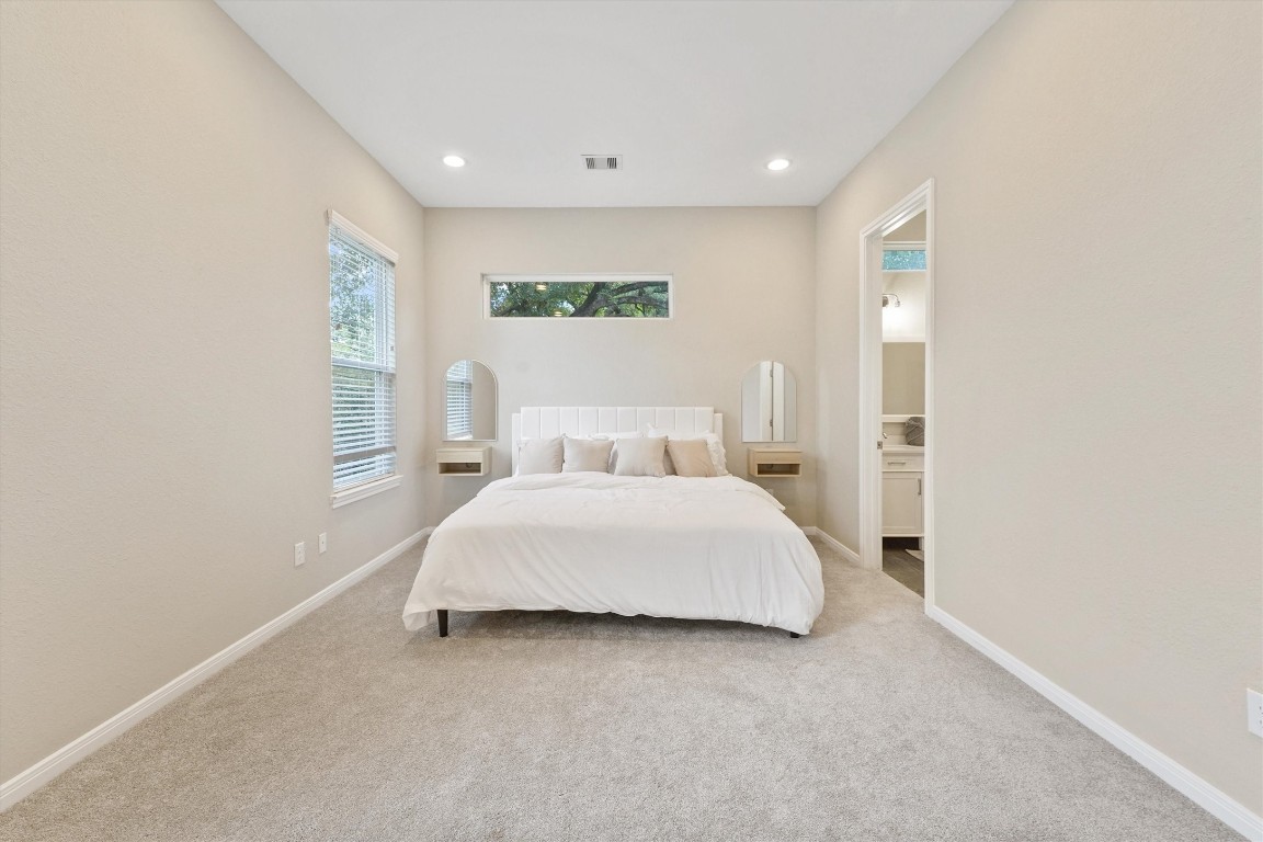 5620 Madison Street Houston, TX 77091 - Photo 9 of 17 a spacious bedroom with a bed and a window