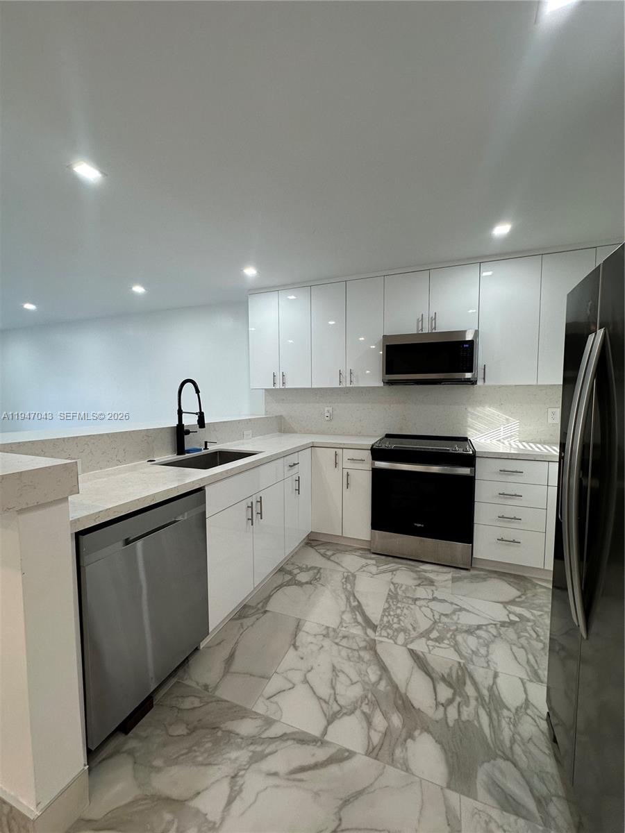 4100 North 58th Avenue, Unit 211 Hollywood, FL 33021 - Photo 1 of 47 a kitchen with stainless steel appliances cabinets a sink and a stove