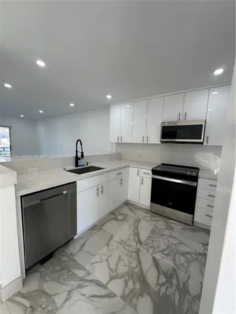 a kitchen with a sink stove and microwave