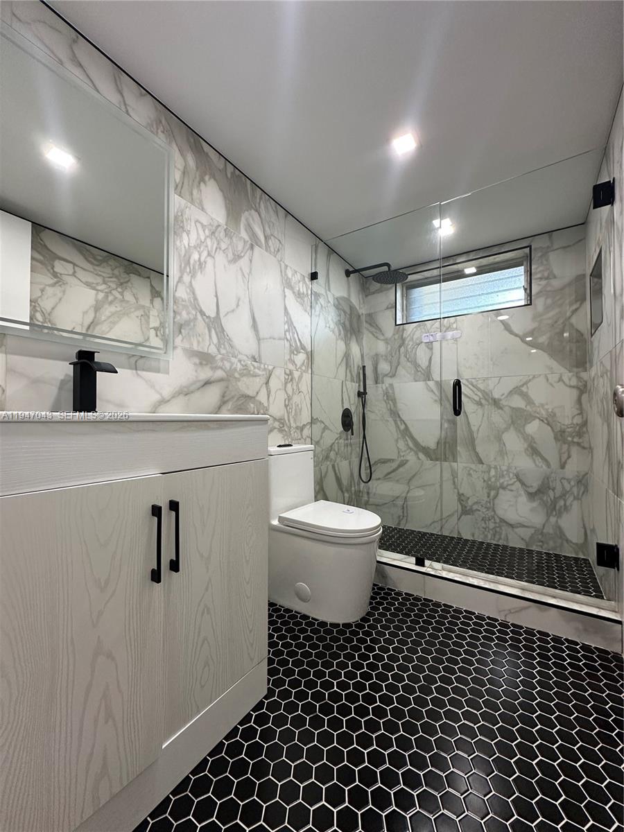 4100 North 58th Avenue, Unit 211 Hollywood, FL 33021 - Photo 23 of 47 a bathroom with a sink toilet a mirror and shower