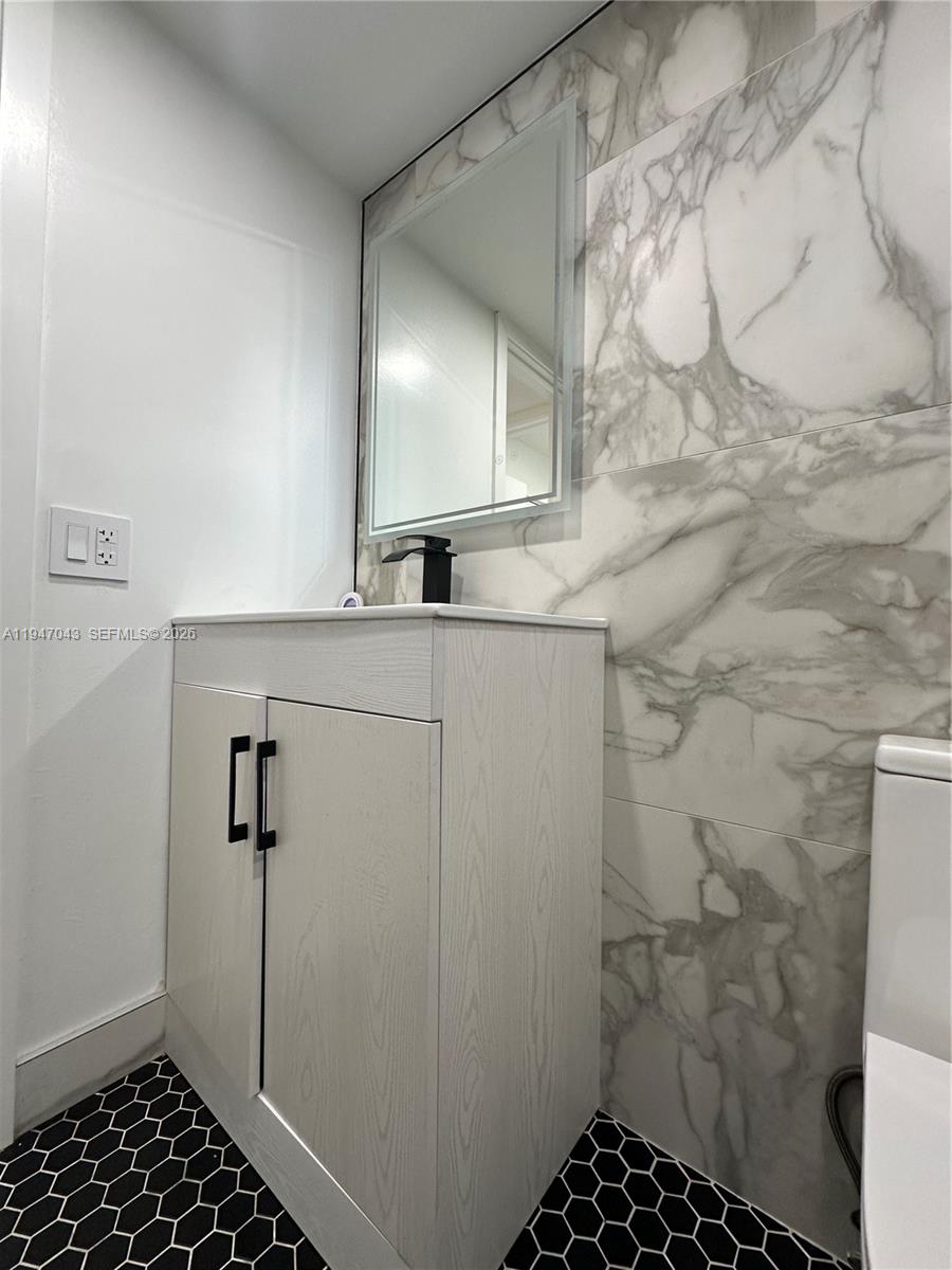 4100 North 58th Avenue, Unit 211 Hollywood, FL 33021 - Photo 25 of 47 a bathroom with a sink a toilet and shower
