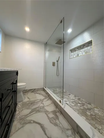 a bathroom with a double vanity sink mirror and toilet