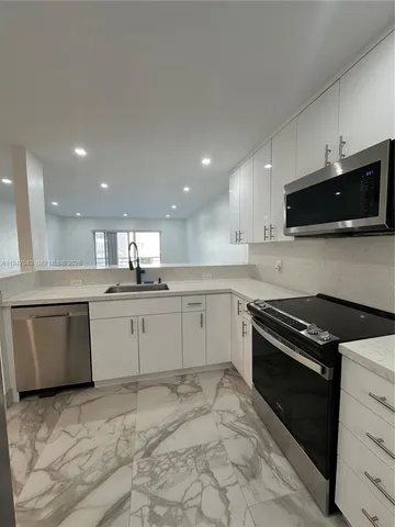 a kitchen with a sink stove and microwave
