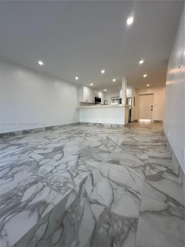 a view of a swimming pool with a patio and a yard