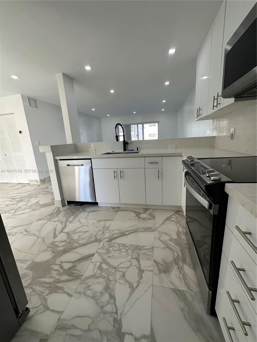 4100 North 58th Avenue, Unit 211 Hollywood, FL 33021 - Photo 5 of 47 a kitchen with a sink stainless steel appliances and cabinets