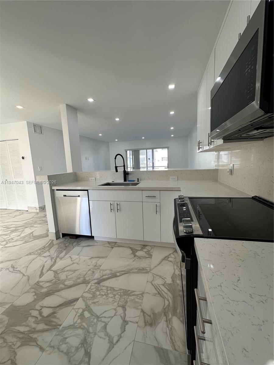 4100 North 58th Avenue, Unit 211 Hollywood, FL 33021 - Photo 6 of 47 a kitchen with a sink stainless steel appliances and cabinets