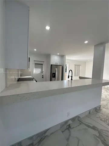 a view of a kitchen with a sink and a stove top oven