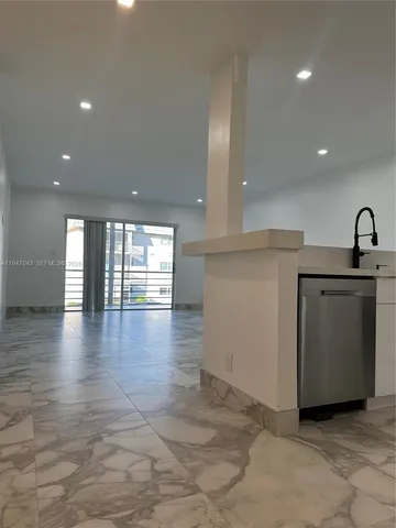 a kitchen with stainless steel appliances granite countertop a sink a stove a microwave and cabinets