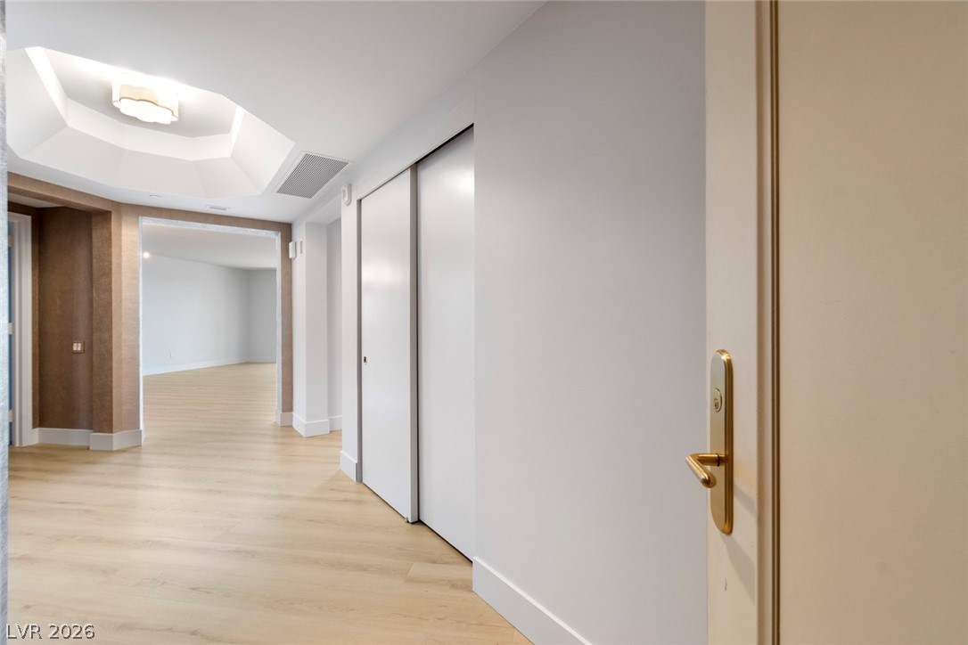 2857 Paradise Road, Unit 403 Las Vegas, NV 89109 - Photo 3 of 7 Smooth wood floors flow throughout this inviting entry hall with tray ceiling details.
