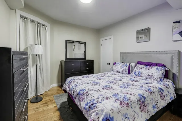 a bed sitting in a bedroom next to a window