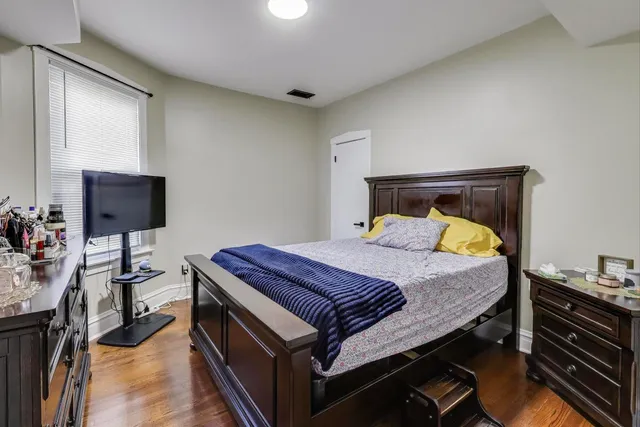 a bedroom with a bed and a television