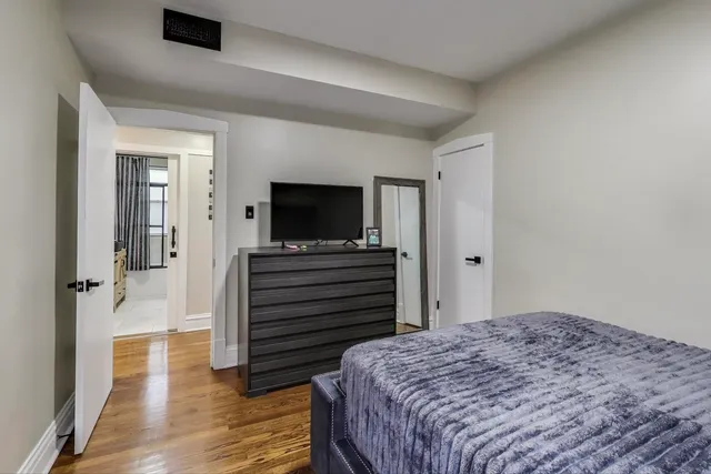 a bedroom with a bed and wooden floor