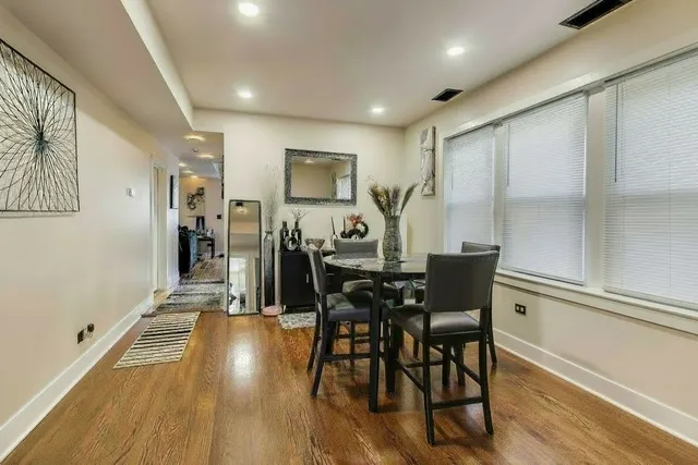 a view of a dining room with furniture and wooden floor