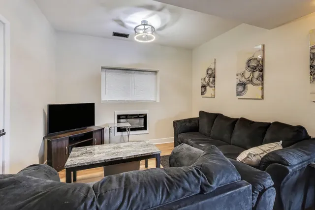 a living room with furniture and a flat screen tv