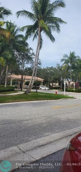 2832 Rio Claro Drive North, Unit 1 Wellington, FL 33414 - Photo 1 of 5 a green field with lots of trees in the background