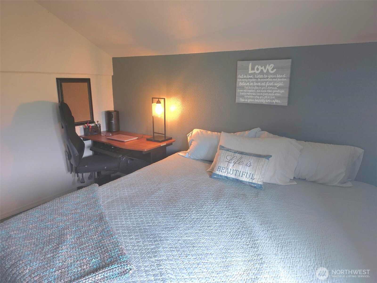2111 B Sargent Road Addy, WA 99101 - Photo 39 of 40 a spacious bedroom with a bed and a lamp with wooden floor