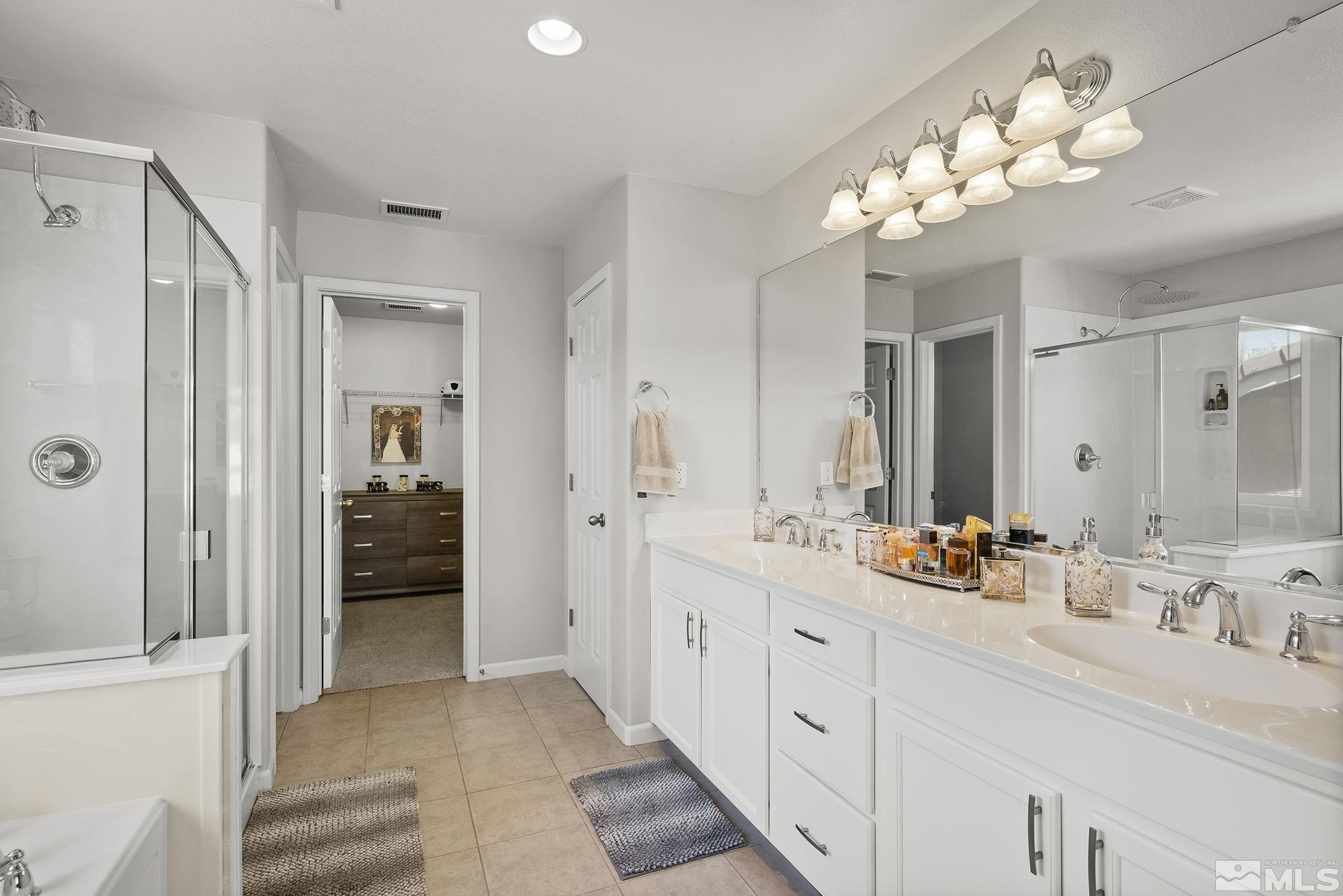 1965 Black Drive Reno, NV 89521 - Photo 22 of 34 a bathroom with a double vanity sink mirror and shower
