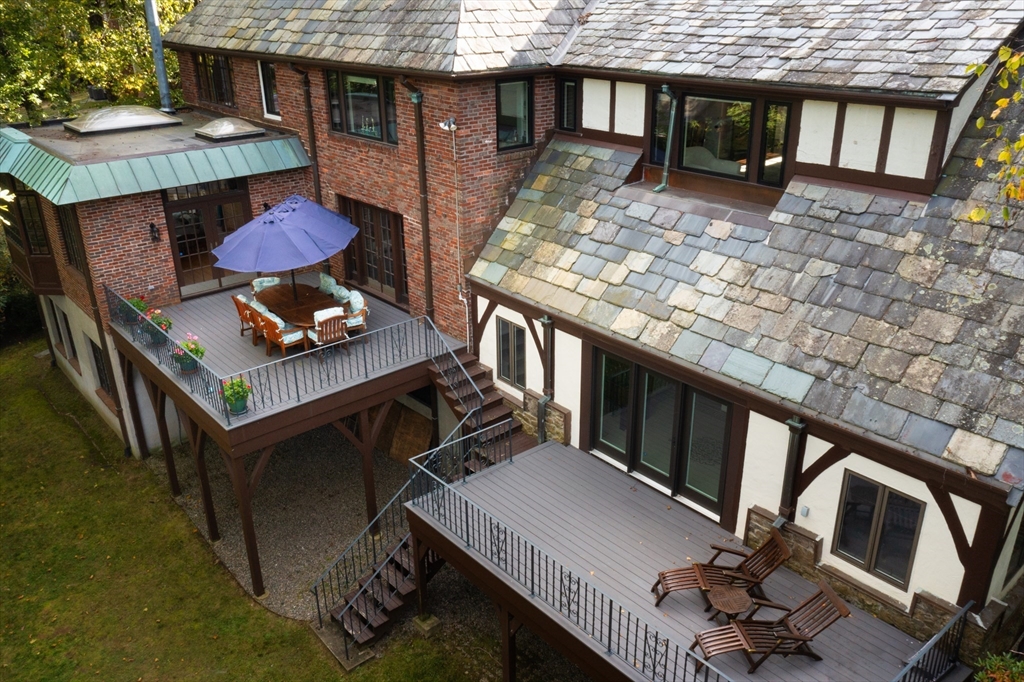 116 Chestnut Hill Road Newton, MA 02467 - Photo 18 of 18 a view of a patio with table and chairs with wooden floor and fence