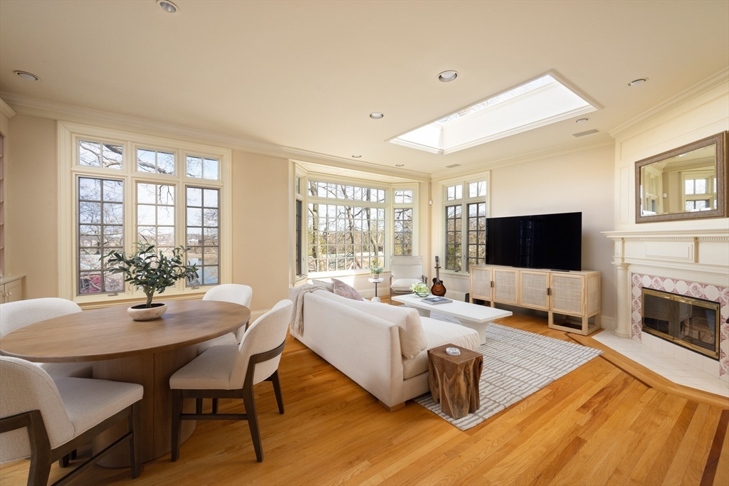 116 Chestnut Hill Road Newton, MA 02467 - Photo 5 of 18 a living room with furniture flat screen tv and a fireplace